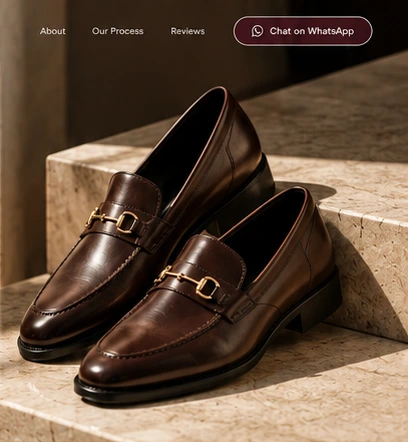 Brown leather horsebit loafers on warm stone steps