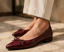 Burgundy bow flats with cream trousers